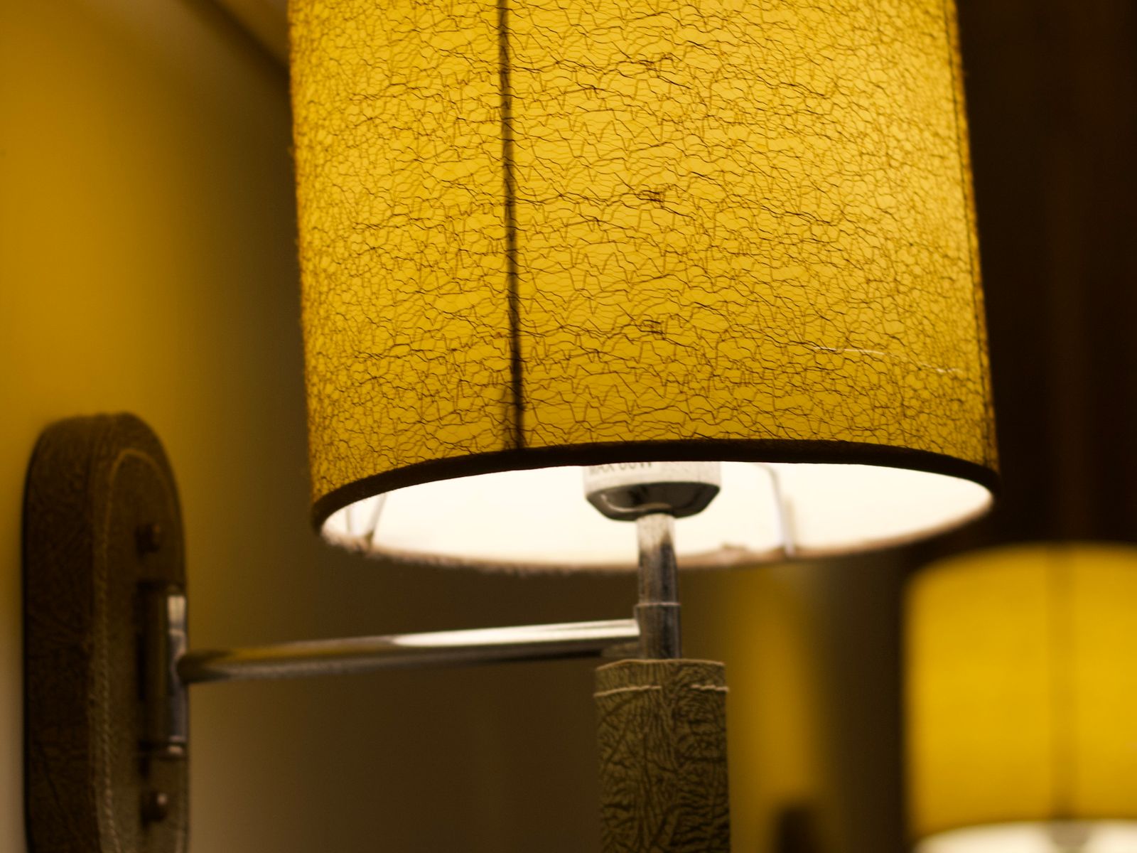A wall lamp adding warm accent light to a rental room