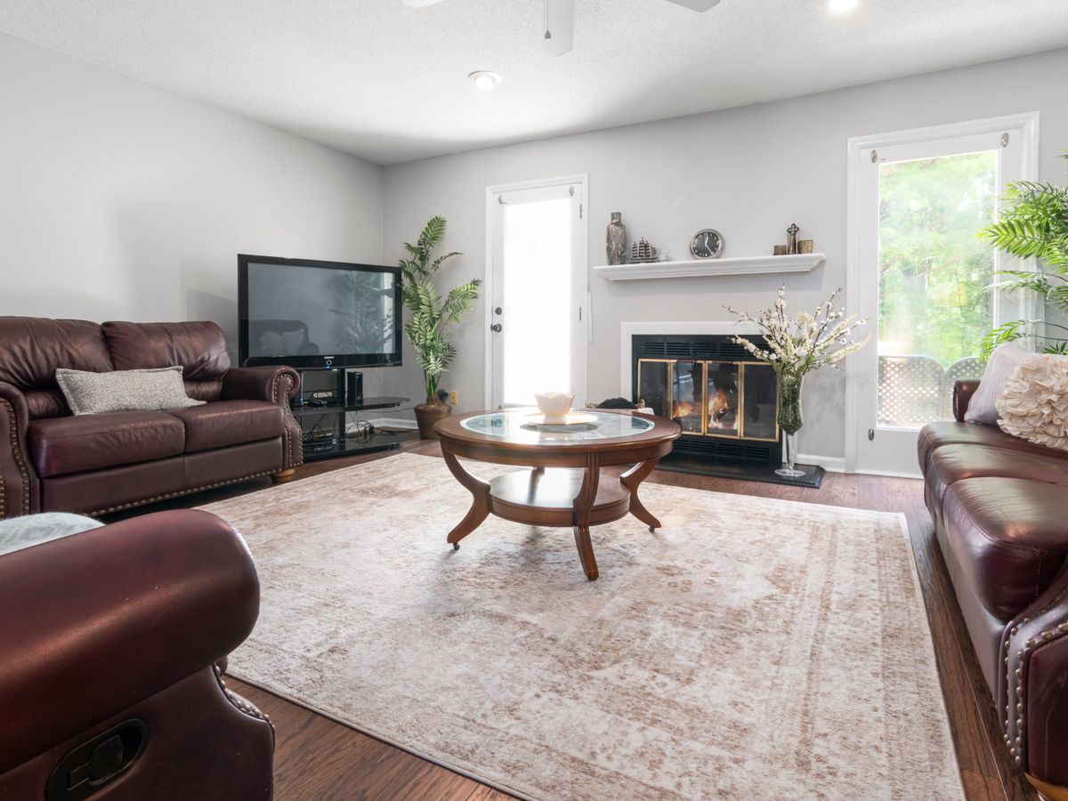 A living room area rug protecting the rental carpet underneath