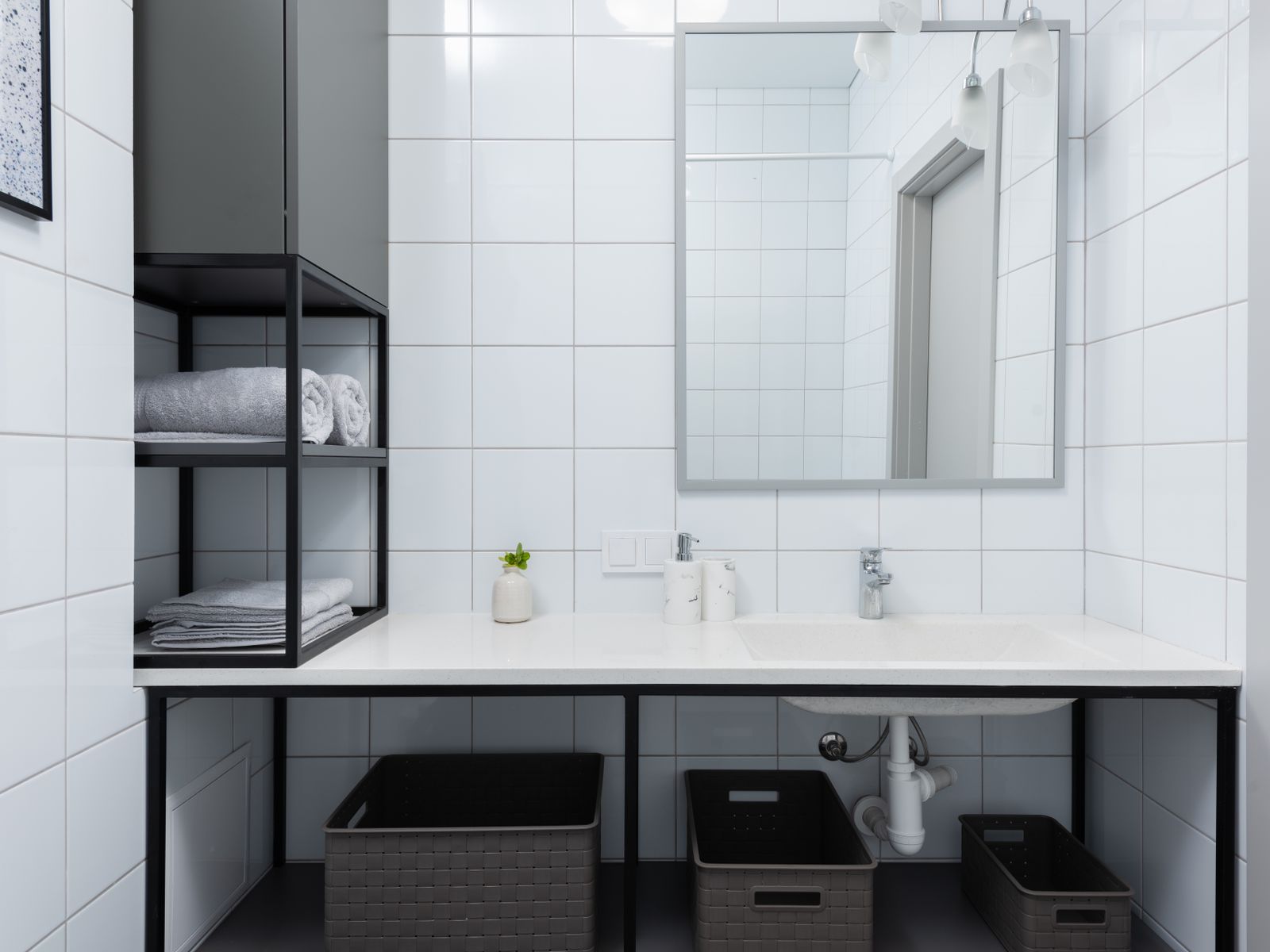 Bathroom shelves with containers and towels providing extra bathroom storage