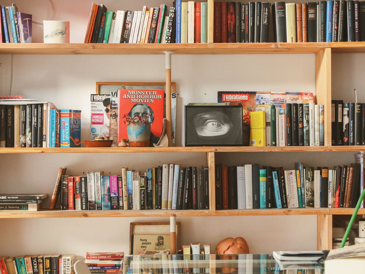 A wooden bookshelf used as a freestanding room divider