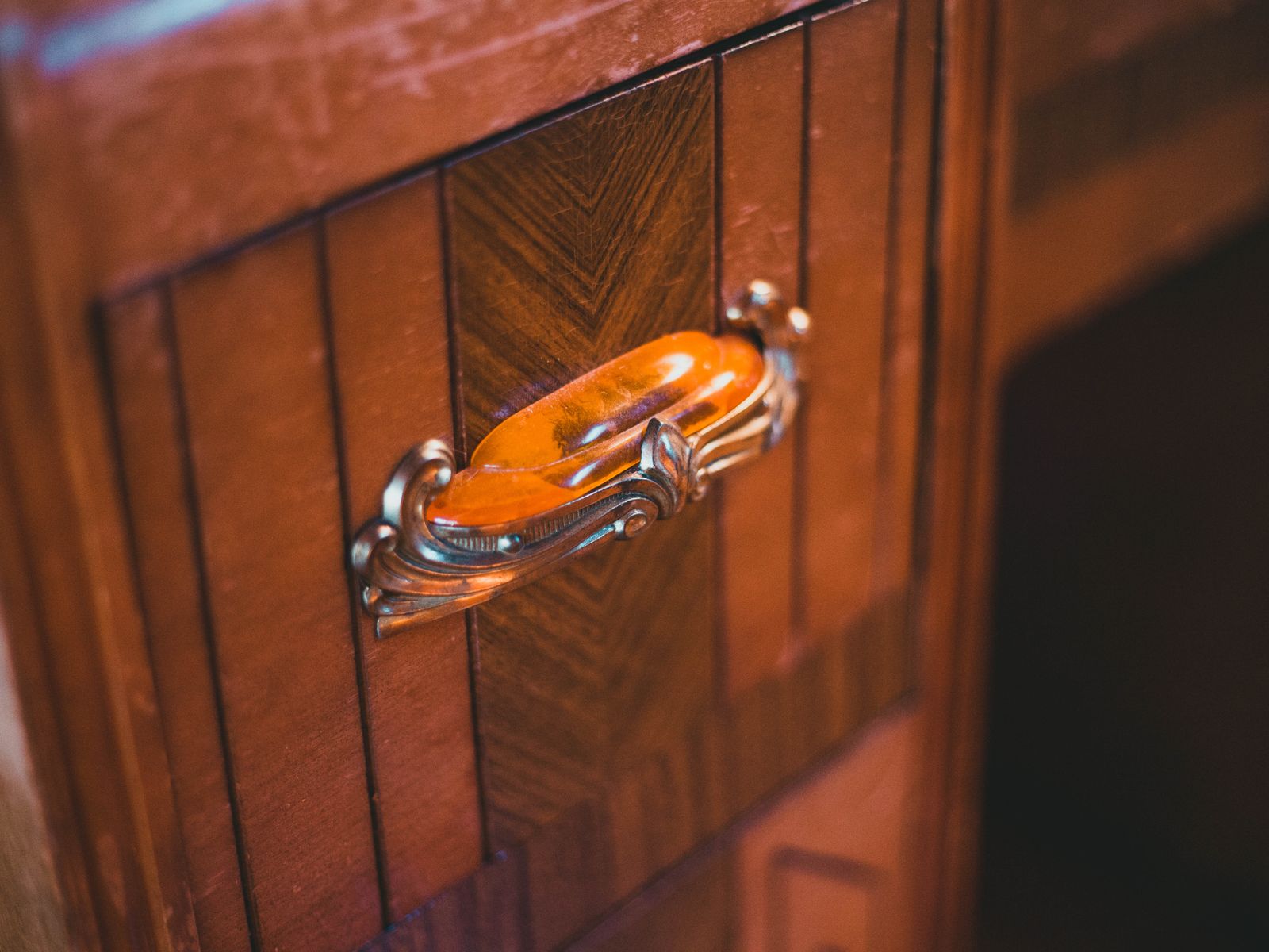Close-up of a decorative cabinet handle showing a cabinet hardware style option