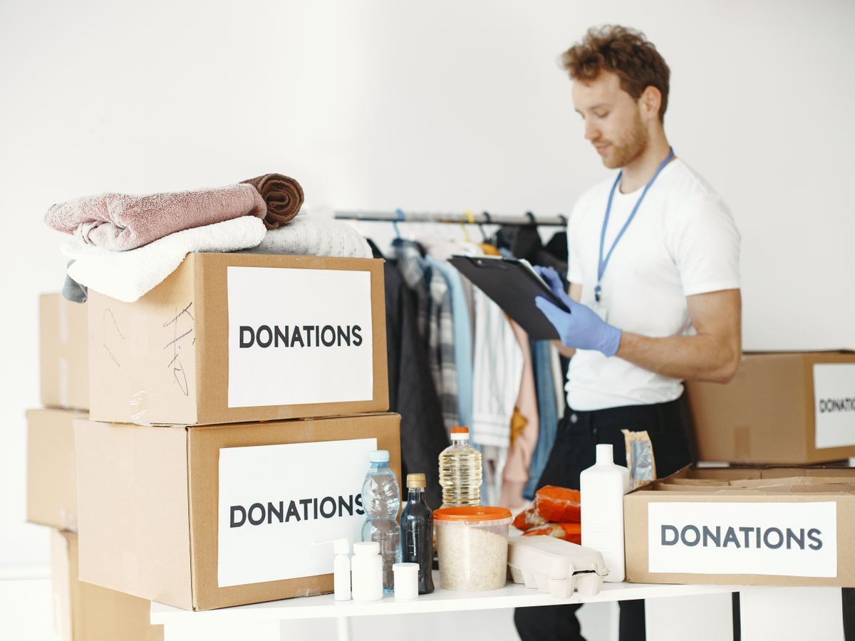 Donation boxes on a table, deciding what stays when you downsize when moving