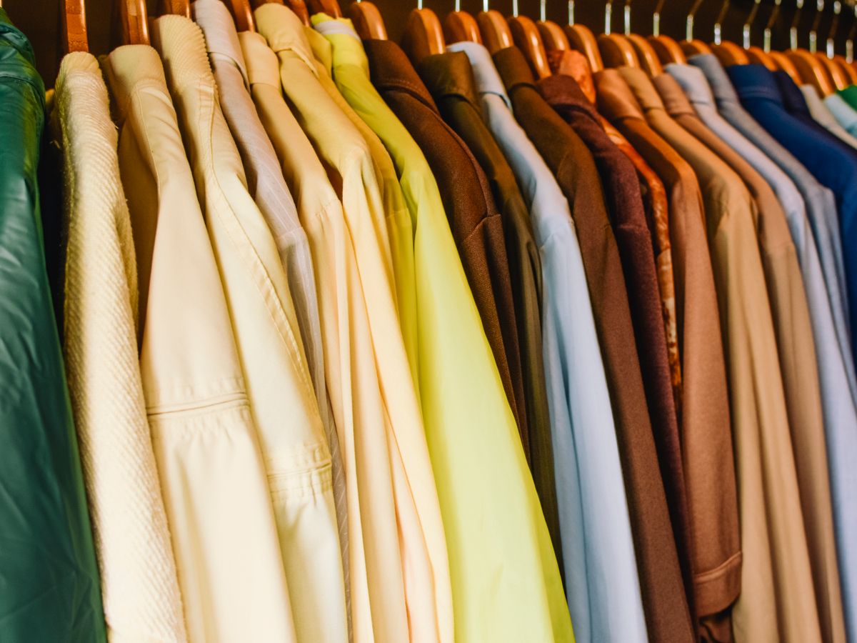 Shirts and jackets on a double hanging rod in a rental closet