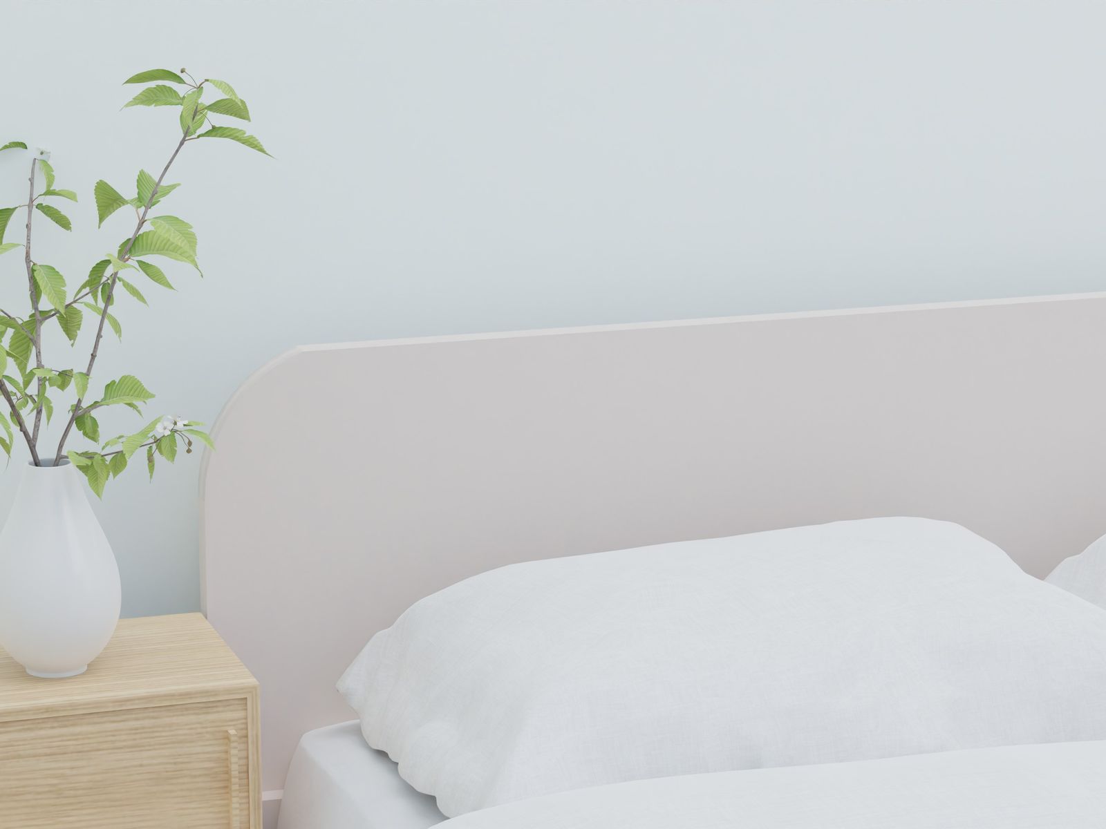 A made bed as a first apartment essential in a new bedroom