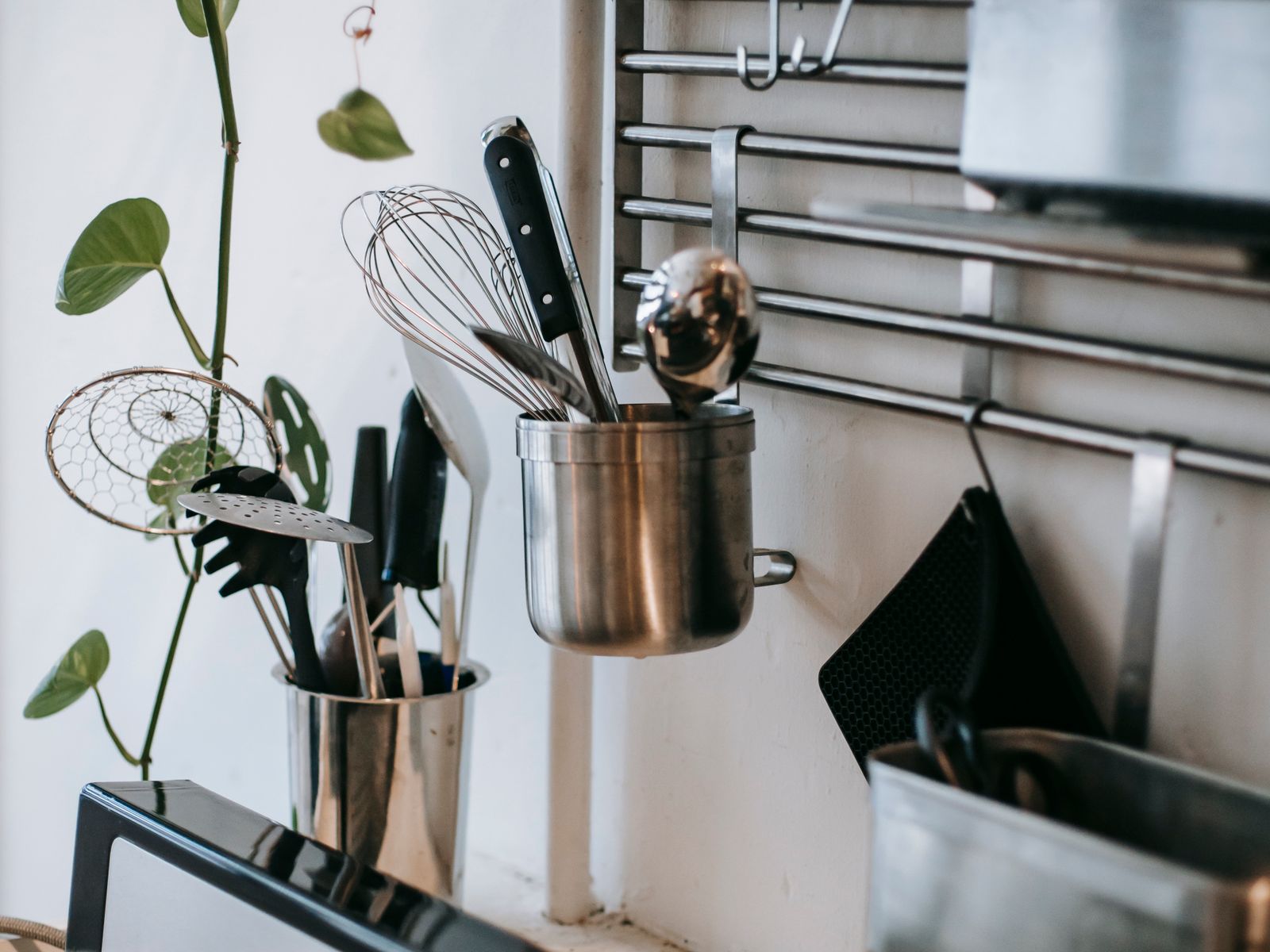 Basic kitchenware among first apartment essentials on a kitchen rack