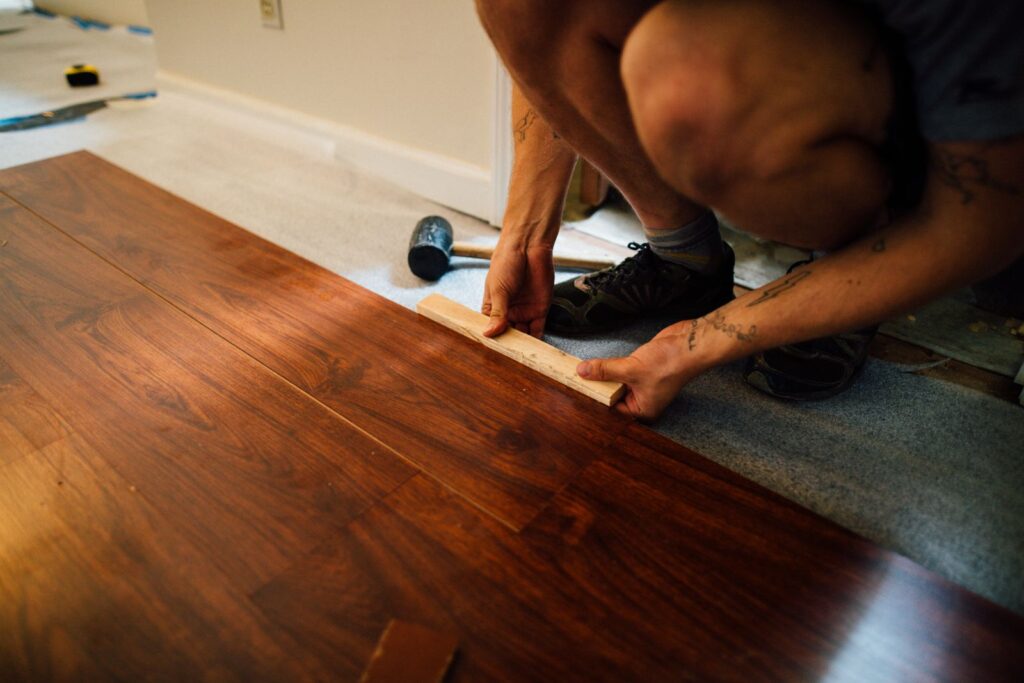 Installing laminate flooring, one way renters fix minor rental damage before moving out