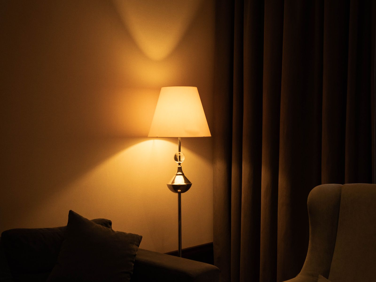 A floor lamp used to upgrade rental lighting in a living room corner