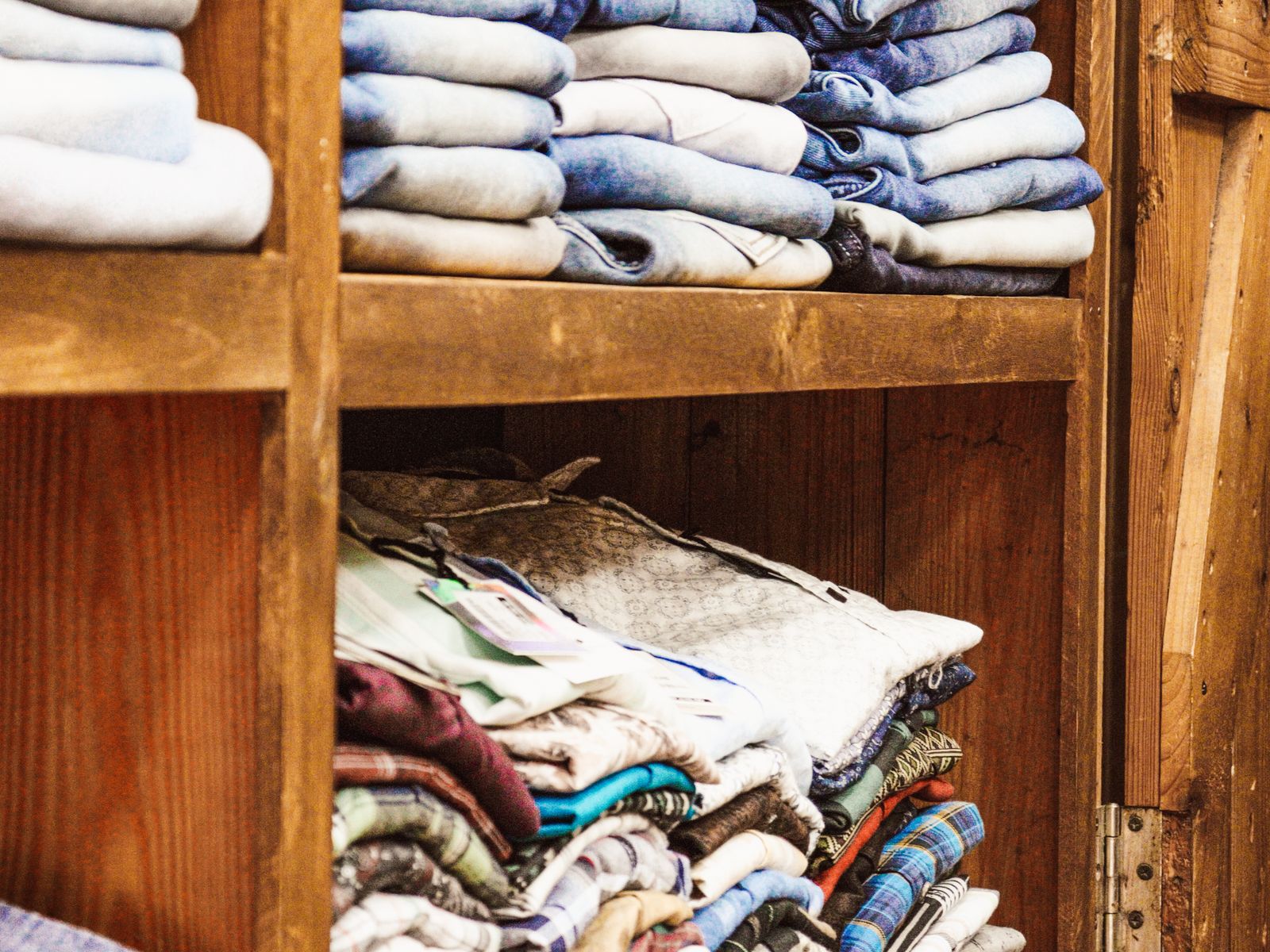 Neatly folded clothes on shelves in an organized rental closet