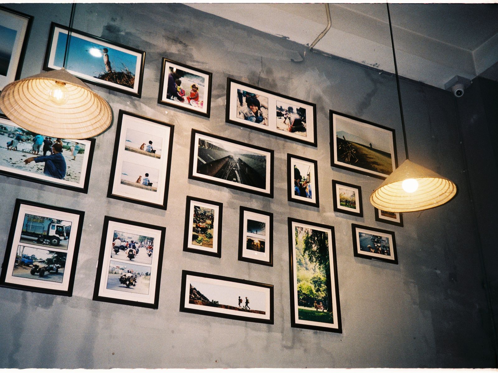 Framed photos arranged on a gray wall without nails