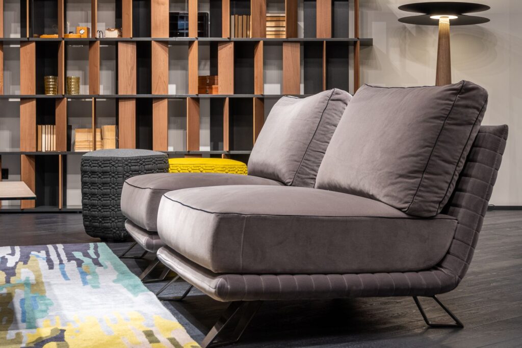 A living room using freestanding furniture, a large bookcase behind a sofa, for storage without built-ins