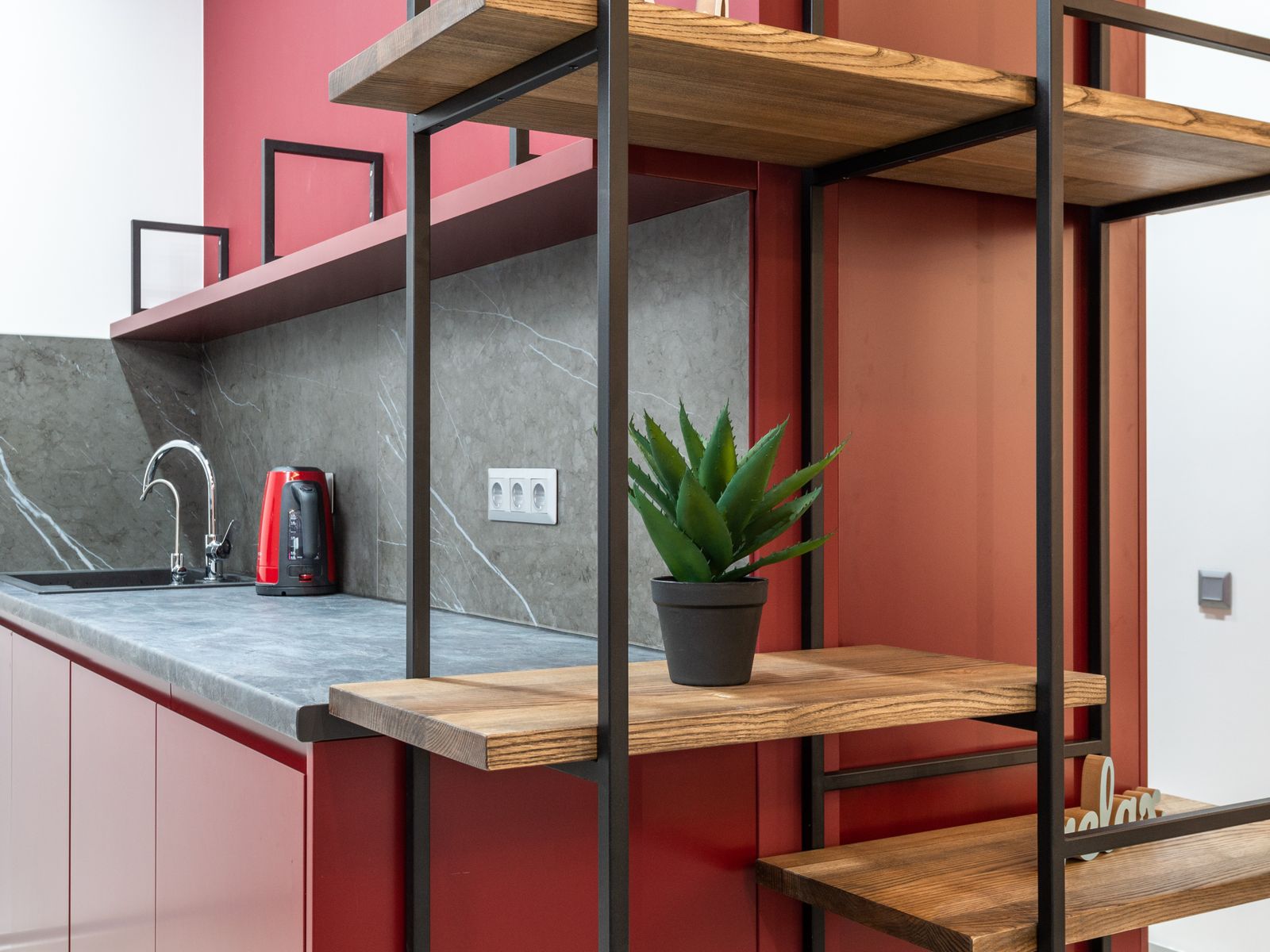 A freestanding shelving unit adding storage to a small rental kitchen