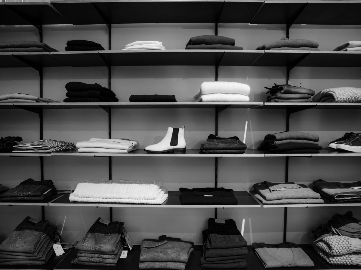 Folded clothing and shoes on freestanding closet shelves to upgrade closet interiors