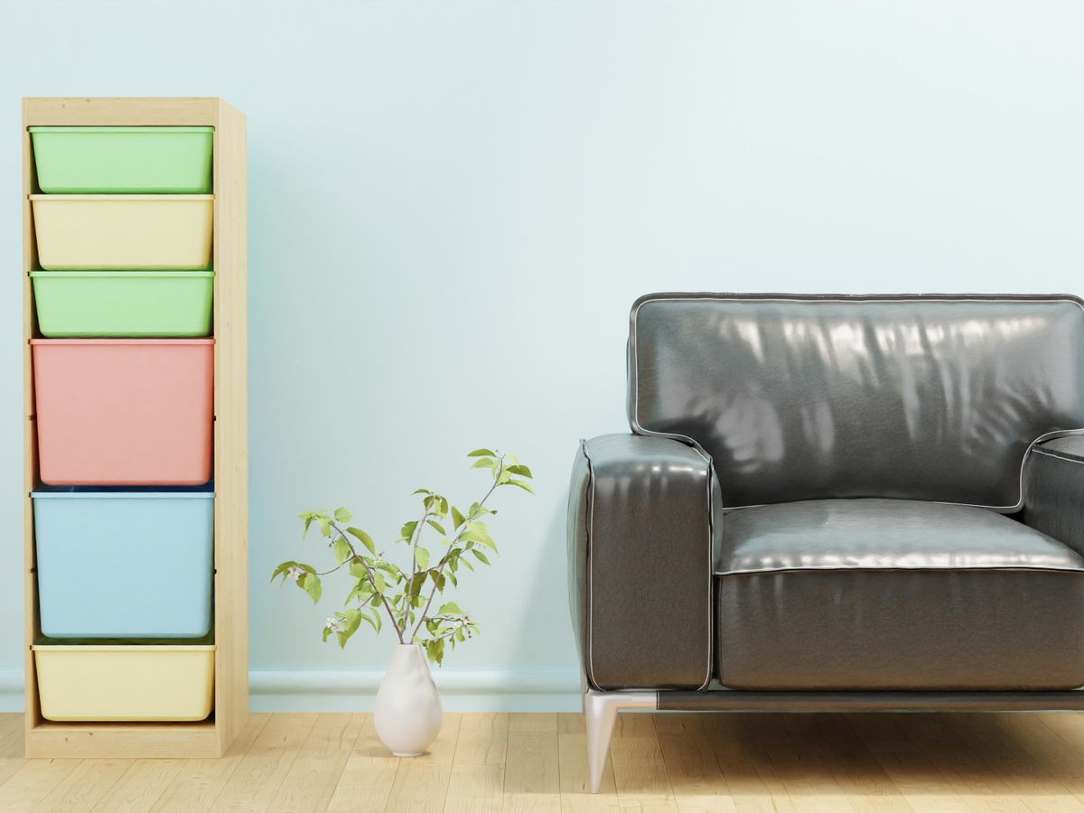 Freestanding cube storage unit with colorful bins beside an armchair in a rental