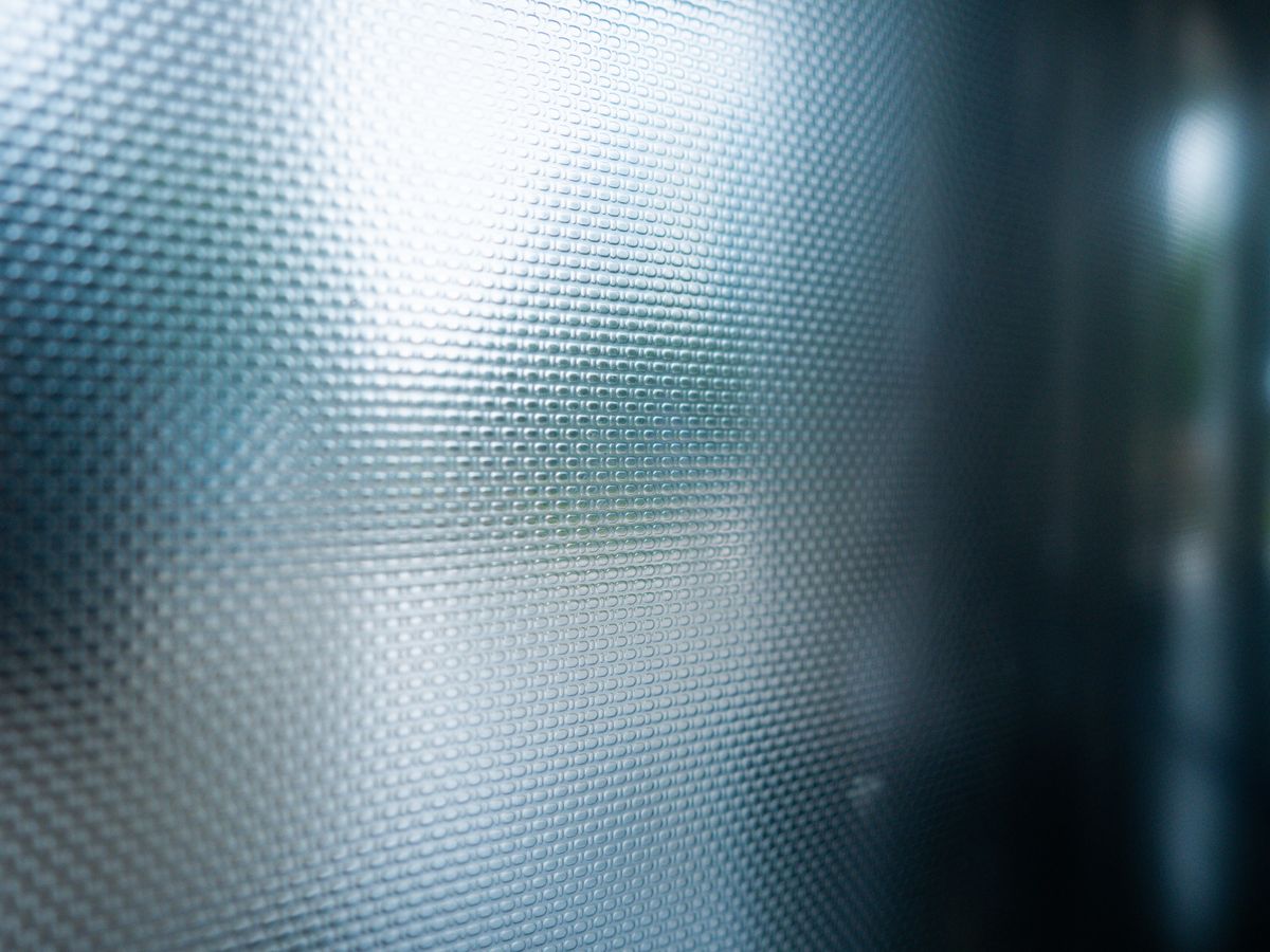 Close-up of textured frosted privacy glass, the effect removable window film creates for daytime privacy