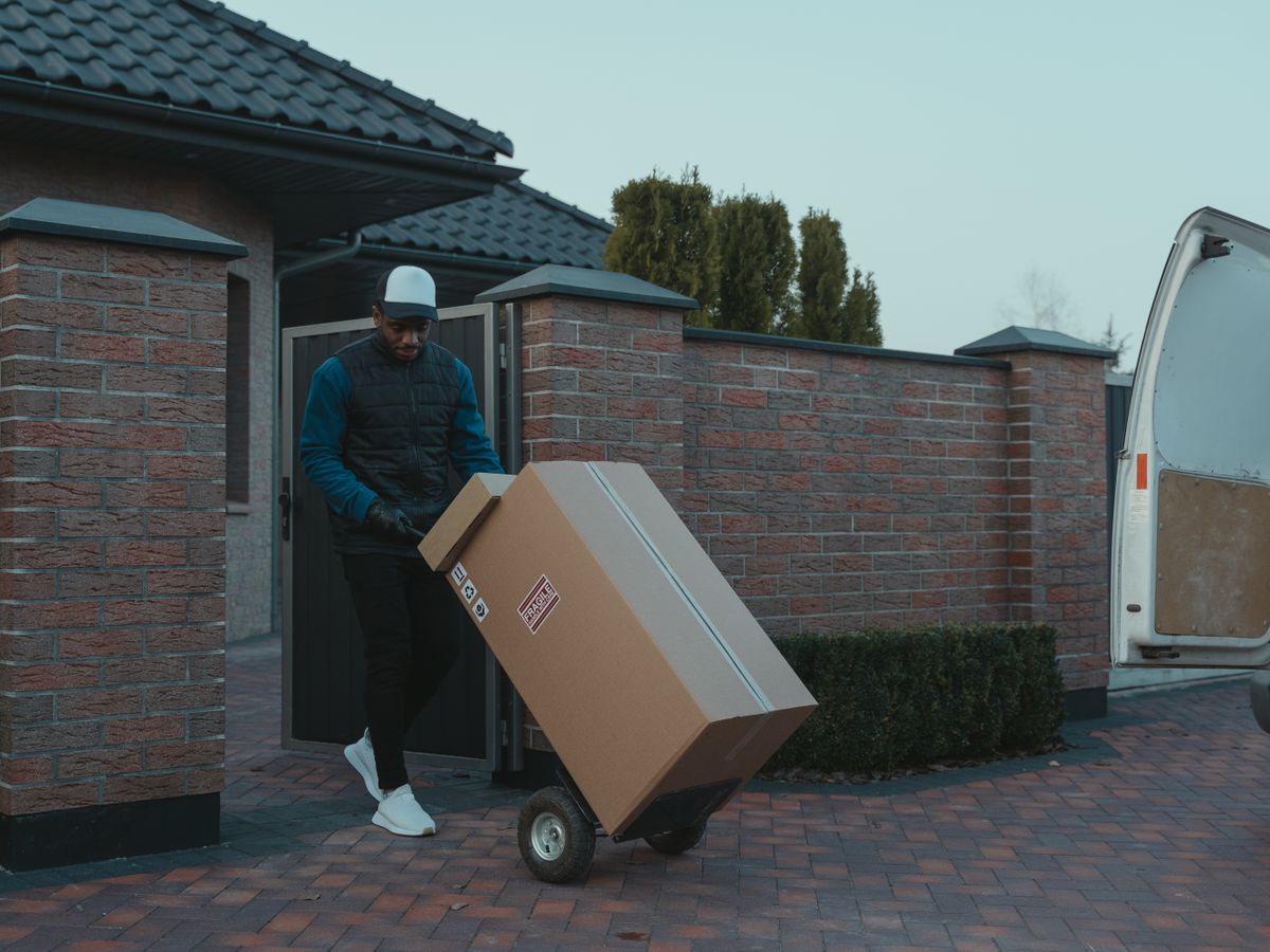 Mover using a hand truck to transport boxes for long-distance moving on a budget