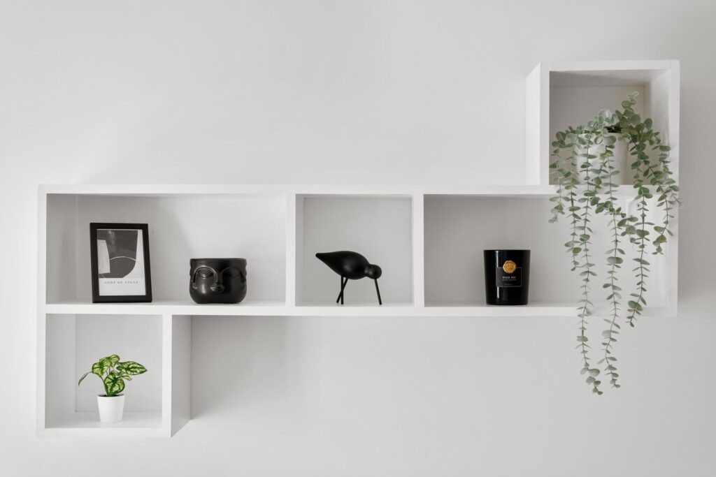 Wall shelves installed without drilling holding plants and decor in a rental