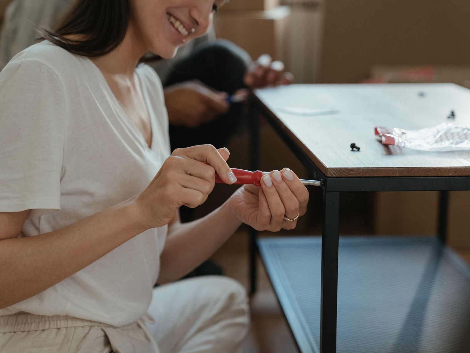 Person using a screwdriver to swap cabinet hardware in about 20 minutes