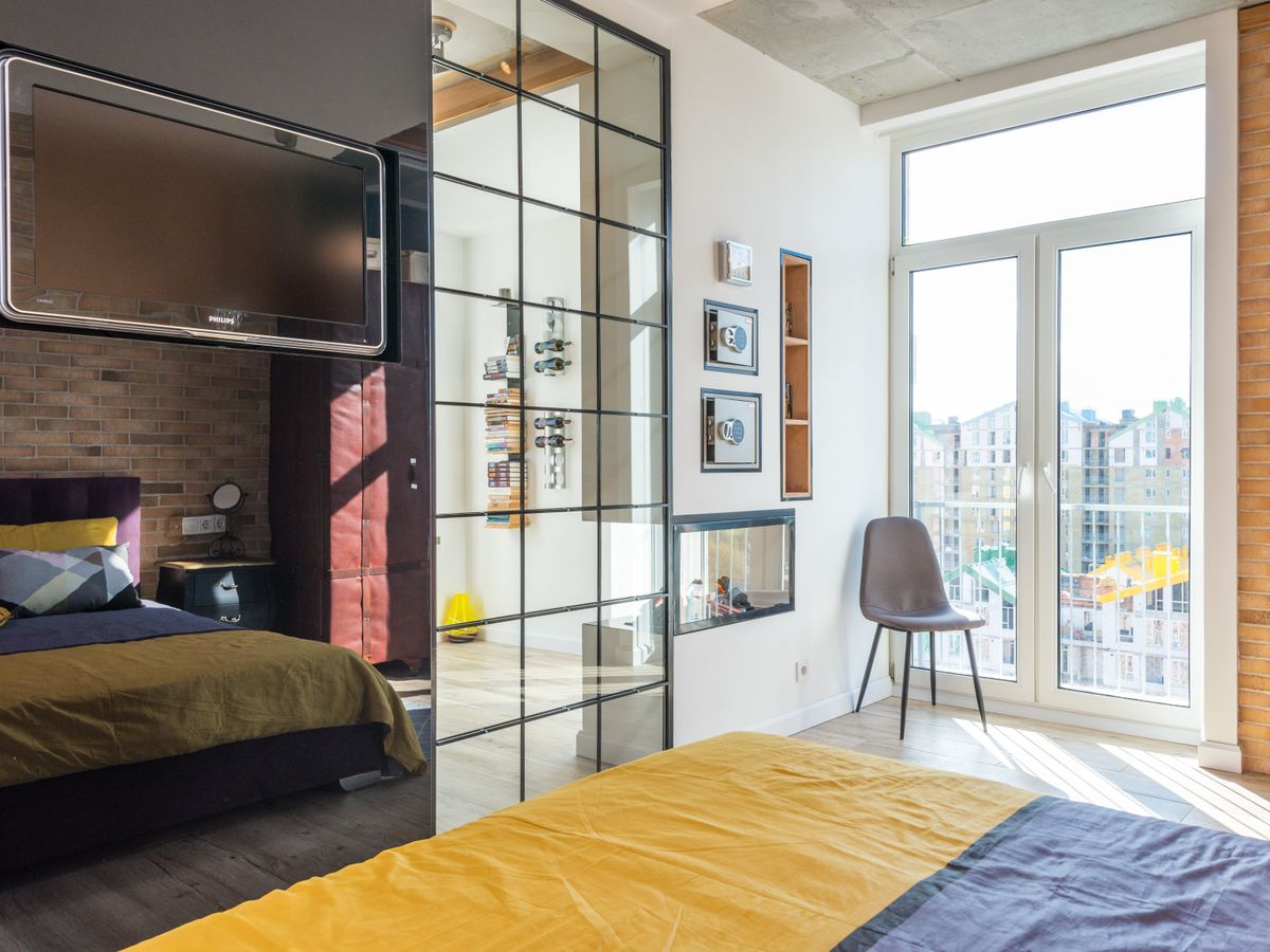 A large decorative mirror in a bedroom, a safe way to hang heavy mirrors by leaning