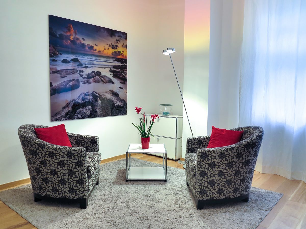 A rug and warm lamp light that help a new rental feel like home