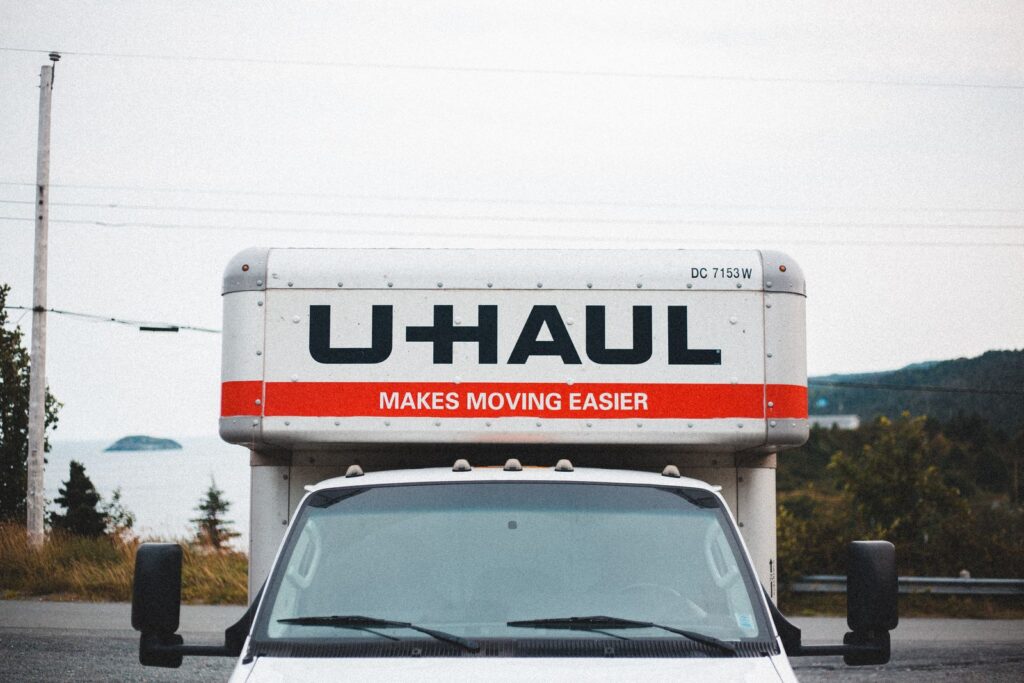 Moving truck parked on a roadside ready for long-distance moving on a budget