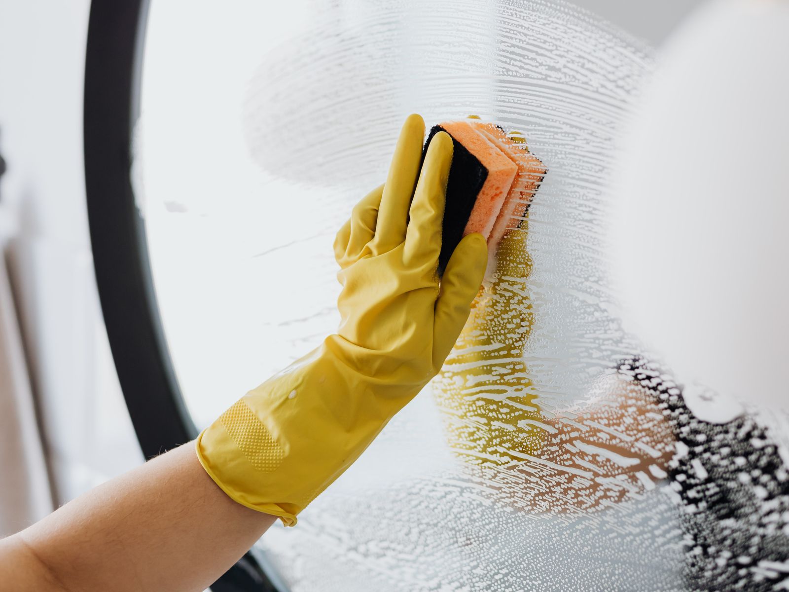 Cleaning a bathroom mirror before a move-out inspection