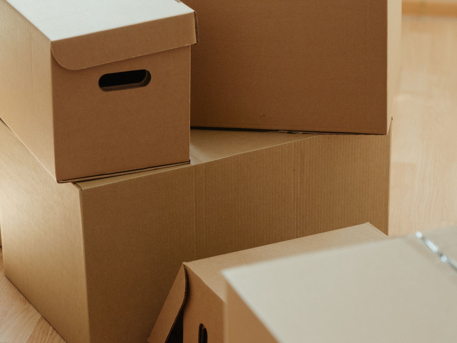 Moving boxes stacked on the floor early in an apartment move