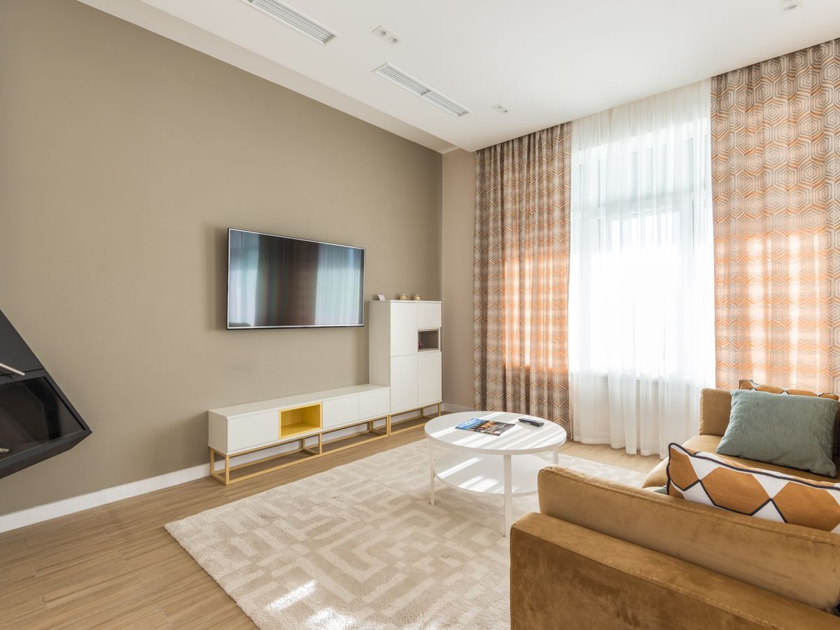 A bright, organized small living room with clear surfaces after a reset