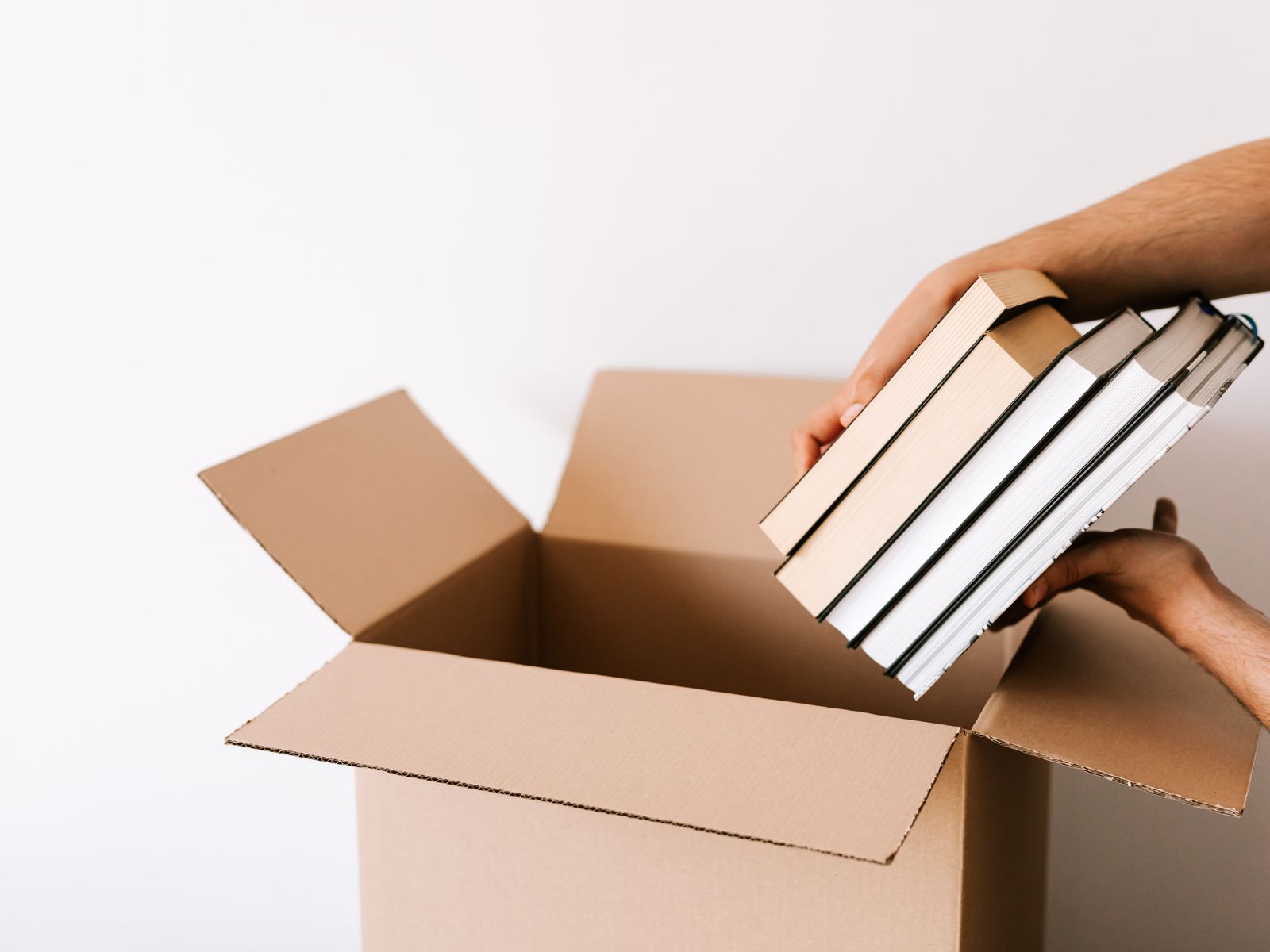 Packing books into a carton box room by room