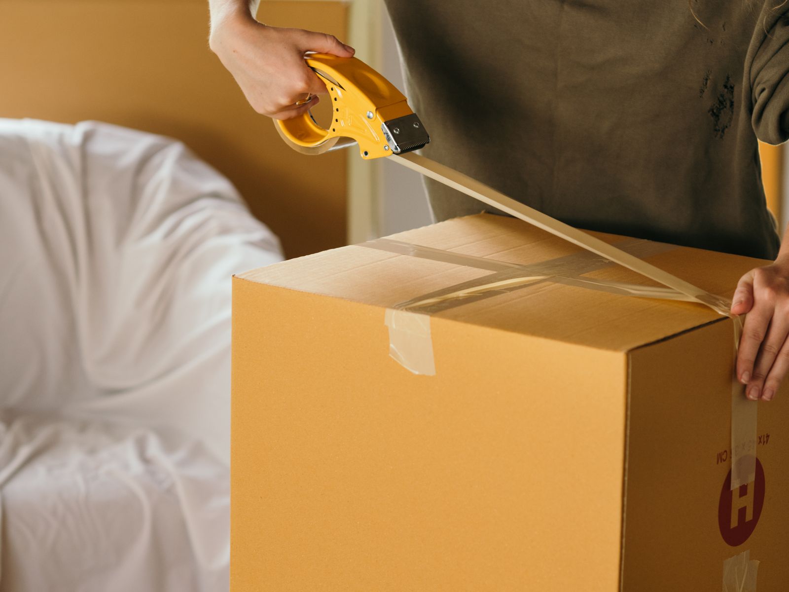Gathering boxes and tape to pack an apartment quickly