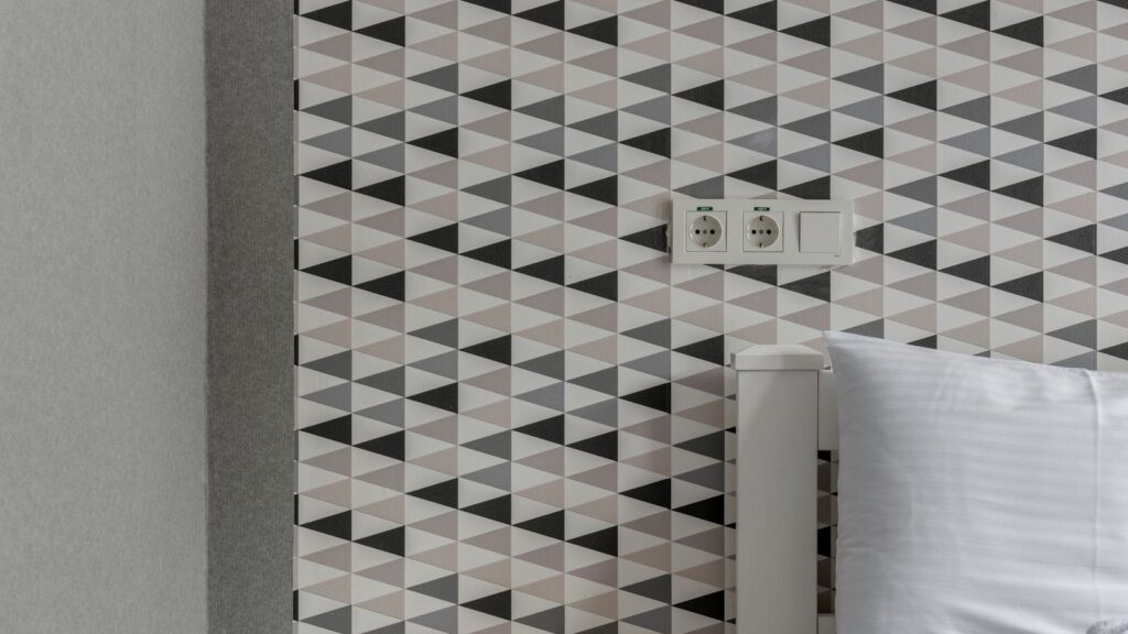 Peel-and-stick wallpaper with a geometric pattern in a rental bedroom