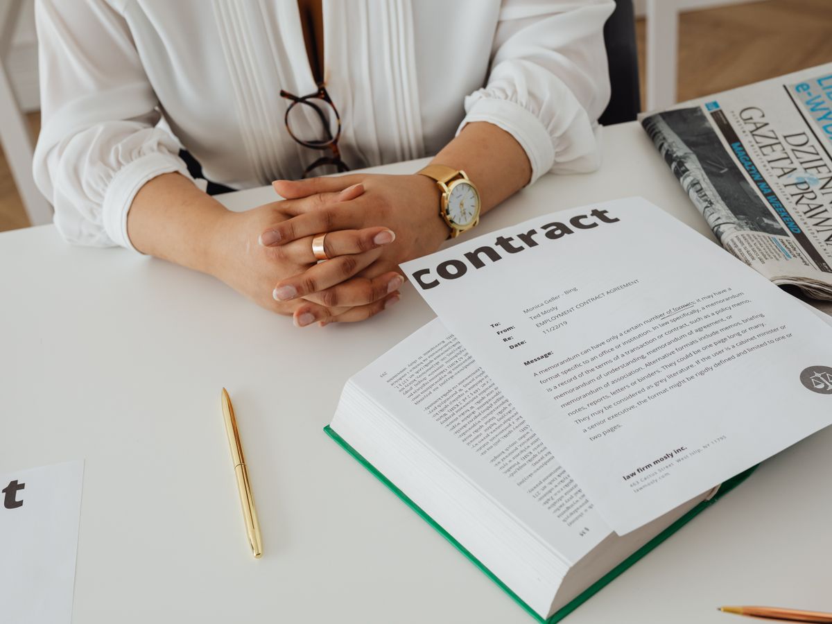 Renter reading a lease contract at a desk to check the deposit and condition clauses