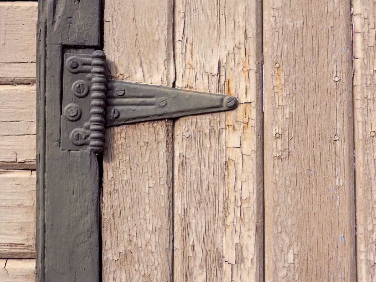 A wooden door with a handle, showing hardware renters can tighten and repair