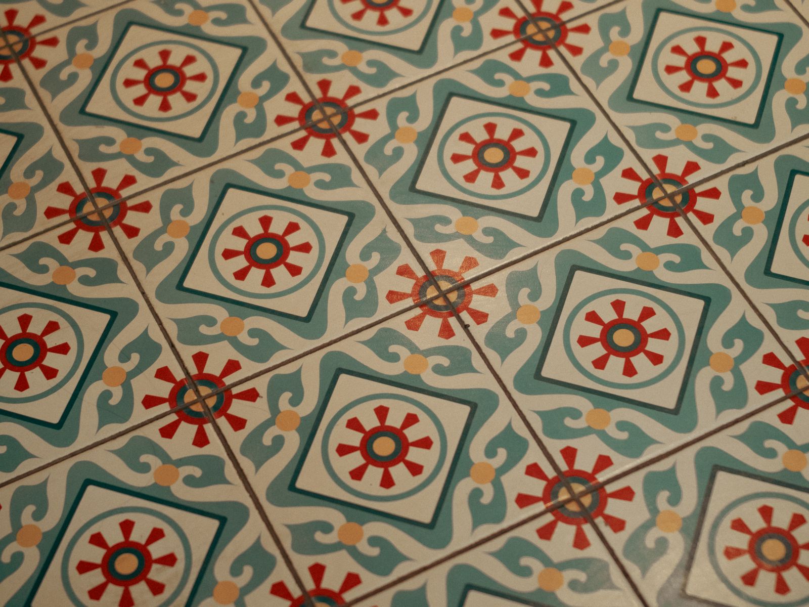 Peel-and-stick floor tiles with a patterned design over a rental floor