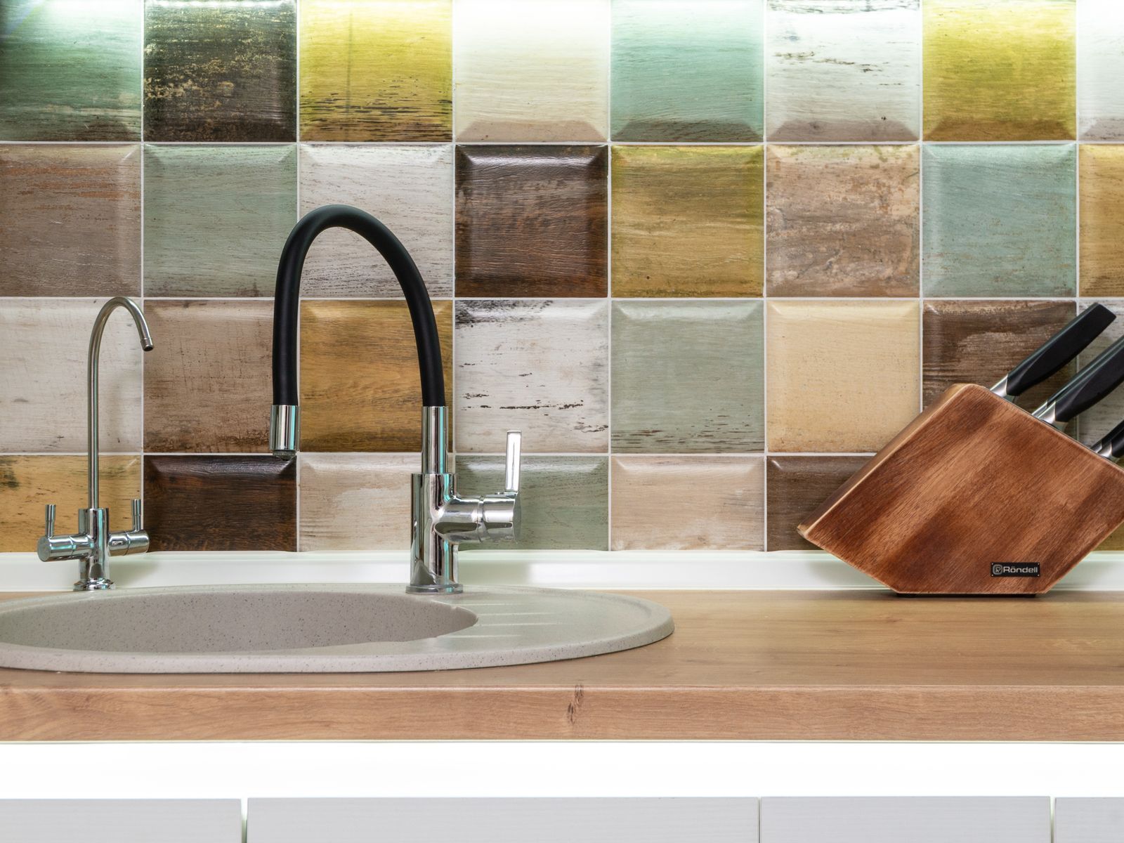 Close-up of a rental kitchen sink and backsplash being documented room by room