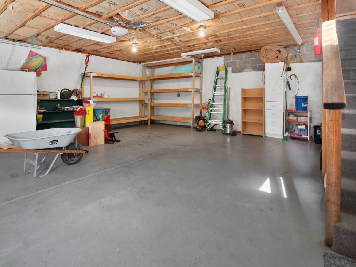 Rented garage interior with freestanding storage shelves and tools
