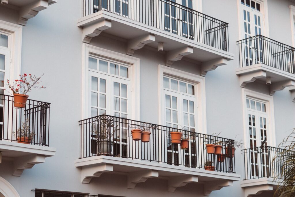 Apartment balconies with potted plants showing renter-friendly balcony and garage storage