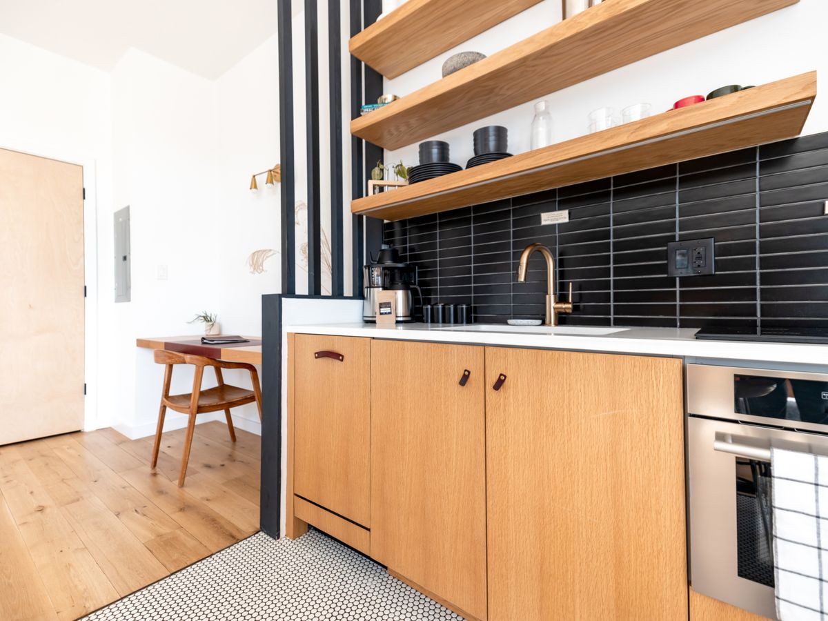 A small kitchen with shelves organized for shared use