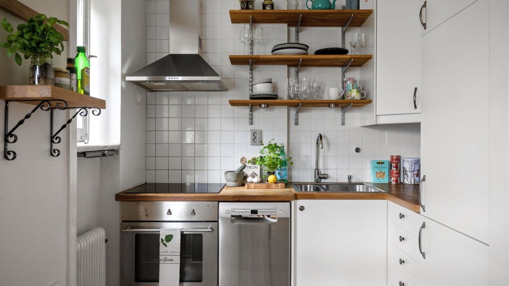 Small rental kitchen organization with open shelving and tidy counters
