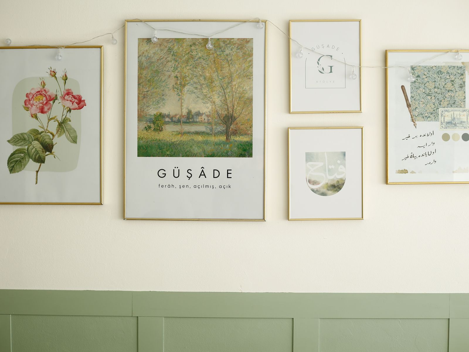 Framed prints and fairy lights arranged on a rental wall as decor