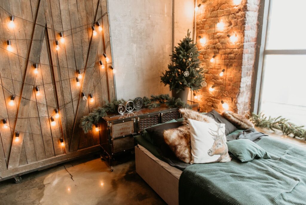 Cozy rental bedroom decorated with warm string lights hung without damage
