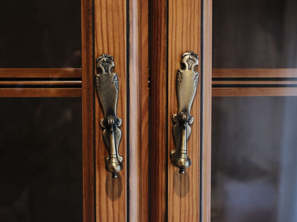 Brass cabinet hardware on a wooden cabinet as a quick rental upgrade