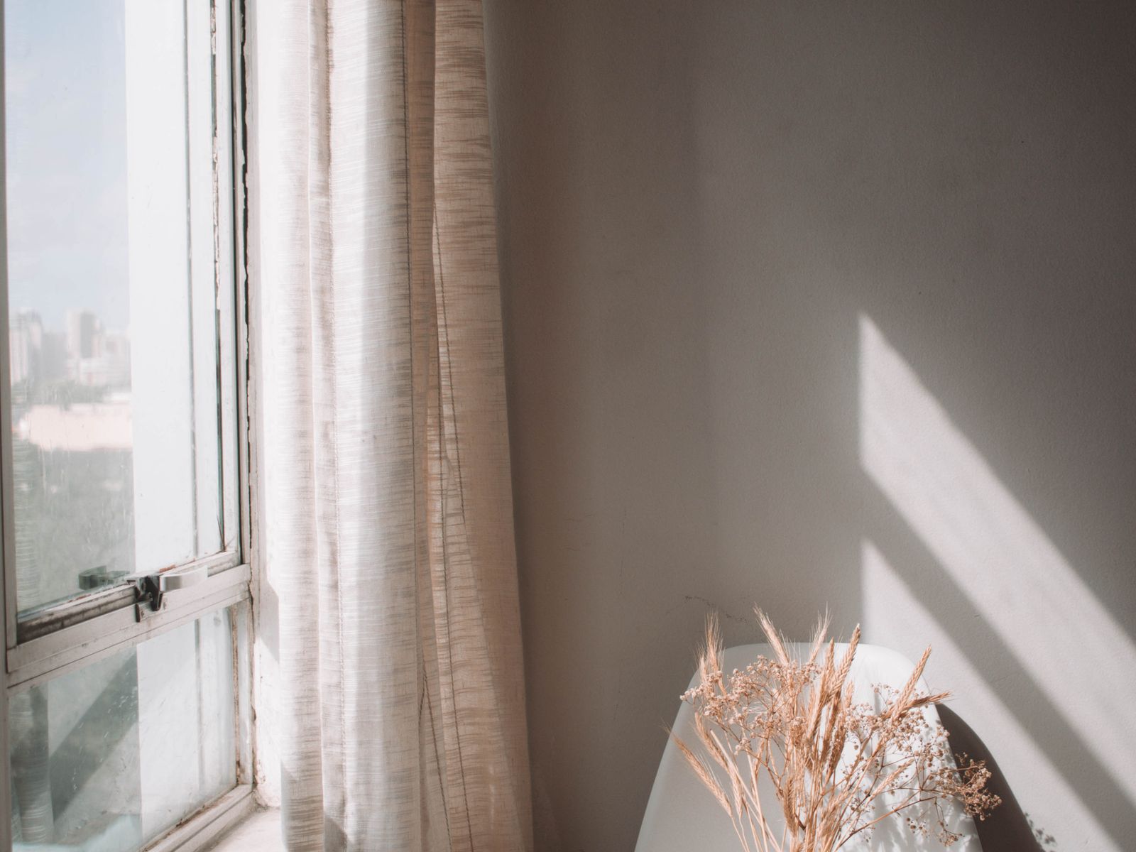 Curtains hanging from a tension rod inside a window frame