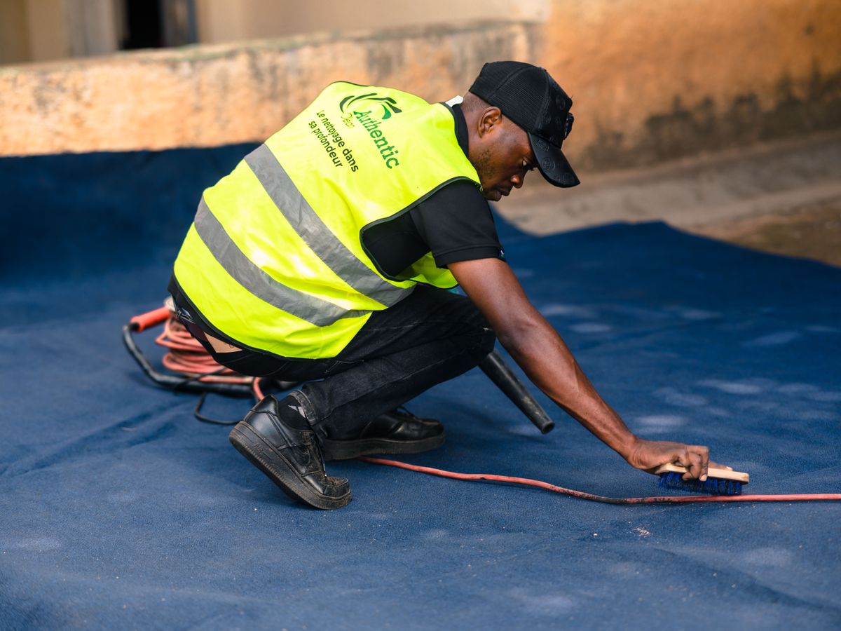Cleaning and treating a carpet stain in a rental by hand