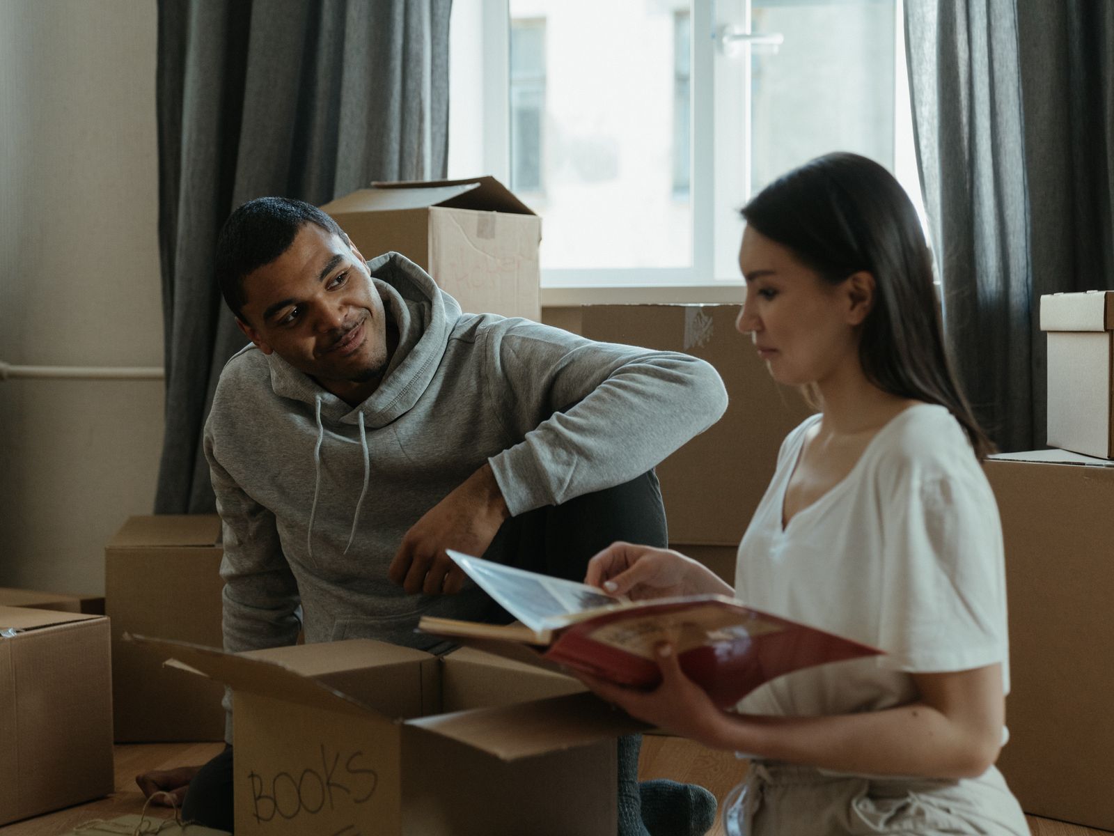 A couple unpacking boxes in their new apartment on move-in day