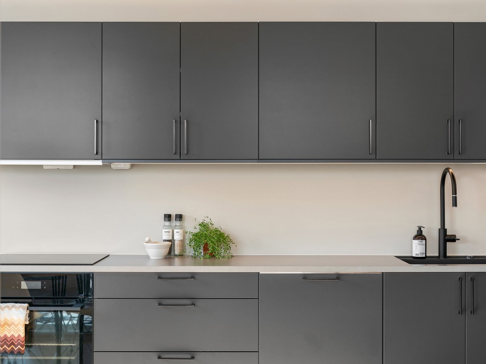 Modern kitchen with dark cabinets and sleek cabinet hardware after an upgrade