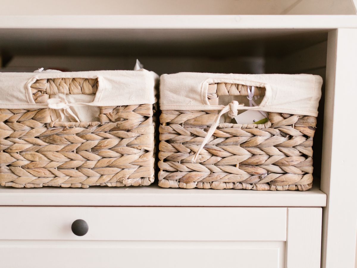 Woven storage baskets neatly arranged on a closet shelf